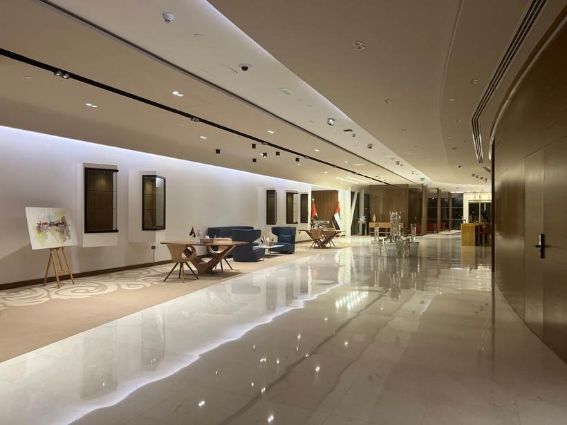 Falcon marble lobby with seating and UAE flags